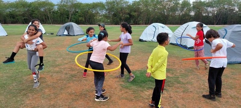 Children playing team games with hoops
