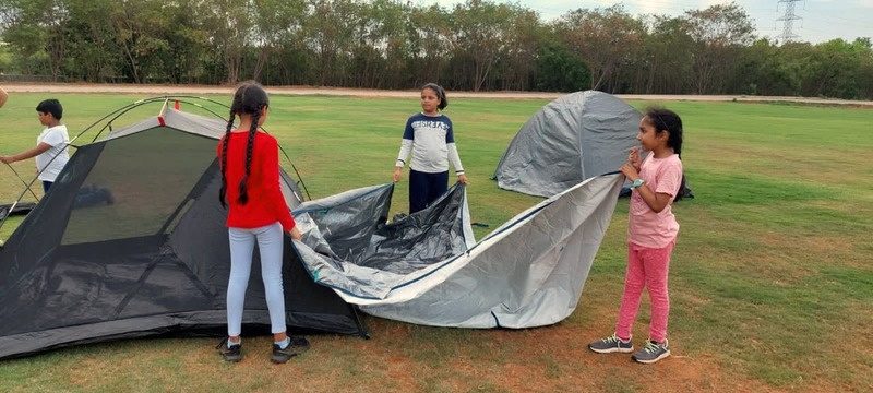 Children setting up a tent together