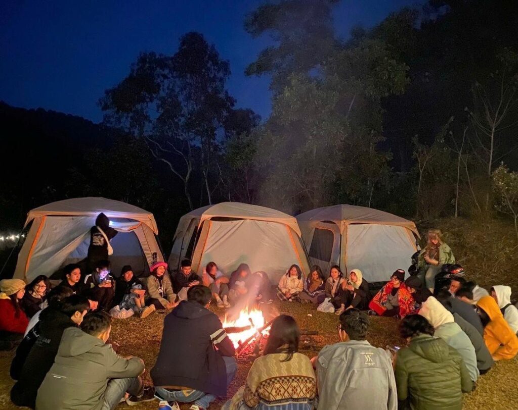 Children gathered around a campfire at night